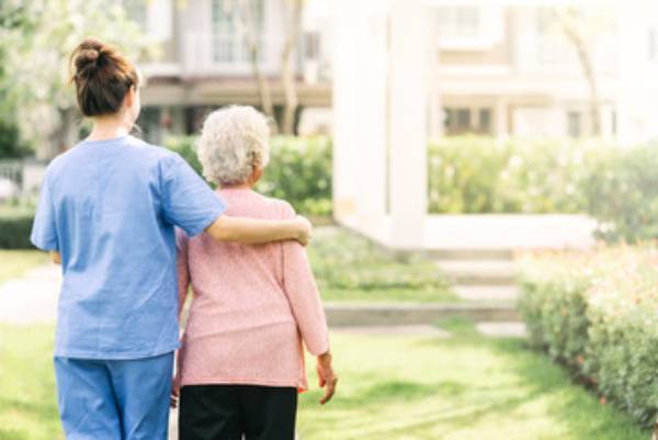 nurse taking care of an elderly woman in a nursing home