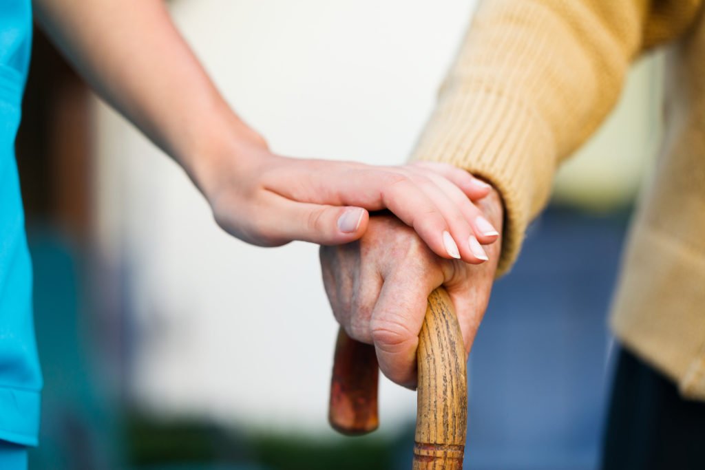 an elderly cared by a nurse in a Nursing-Home